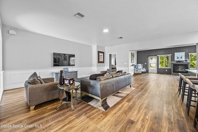 living room featuring hardwood / wood-style floors and a textured ceiling