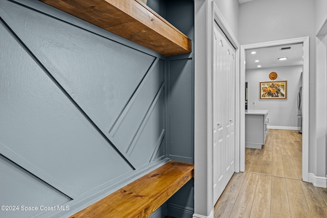 hallway with light hardwood / wood-style flooring