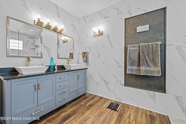 bathroom with tile walls, vanity, and hardwood / wood-style flooring