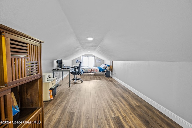 interior space with dark hardwood / wood-style floors and vaulted ceiling