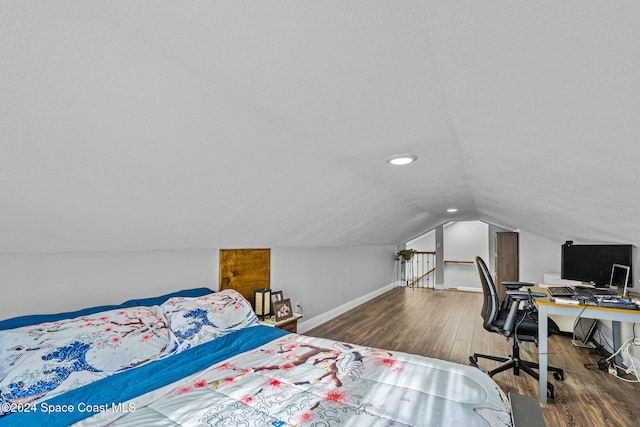 bedroom featuring dark hardwood / wood-style flooring and lofted ceiling