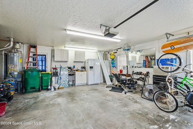 garage featuring water heater, white fridge with ice dispenser, and a garage door opener