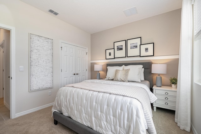 bedroom with light carpet and a closet