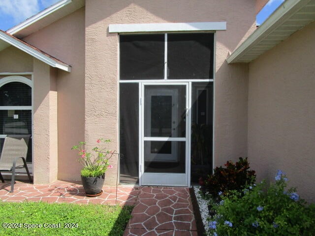 property entrance with a patio area