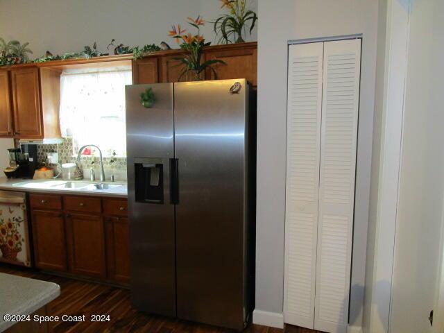 kitchen featuring sink, stainless steel appliances, dark hardwood / wood-style floors, and backsplash