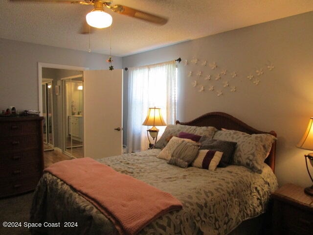 bedroom featuring a textured ceiling and ceiling fan