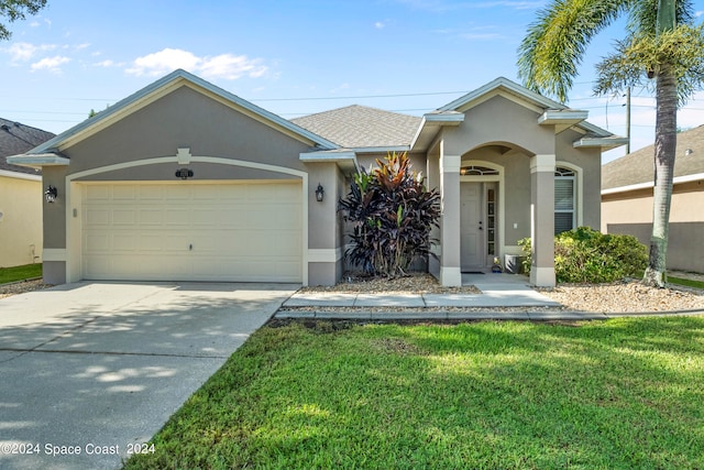 single story home featuring a garage and a front lawn