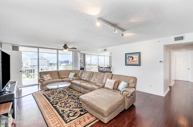 living room featuring track lighting, a textured ceiling, floor to ceiling windows, ceiling fan, and dark hardwood / wood-style floors