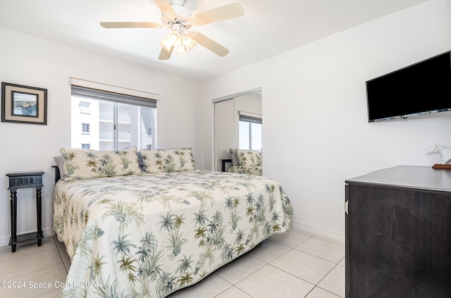 bedroom featuring a closet, ceiling fan, and light tile patterned floors