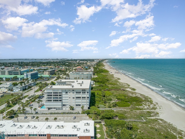 drone / aerial view with a water view and a beach view