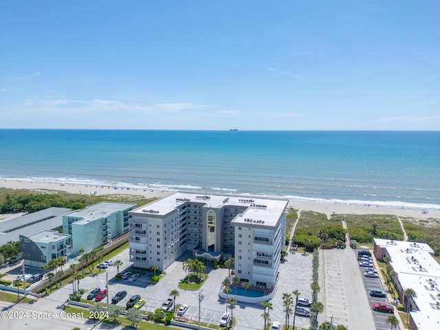 birds eye view of property with a view of the beach and a water view