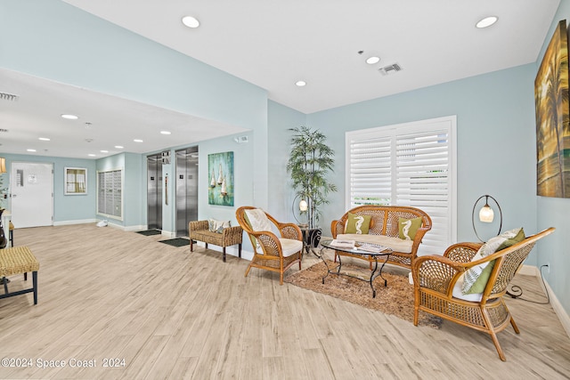 sitting room featuring light hardwood / wood-style flooring and elevator