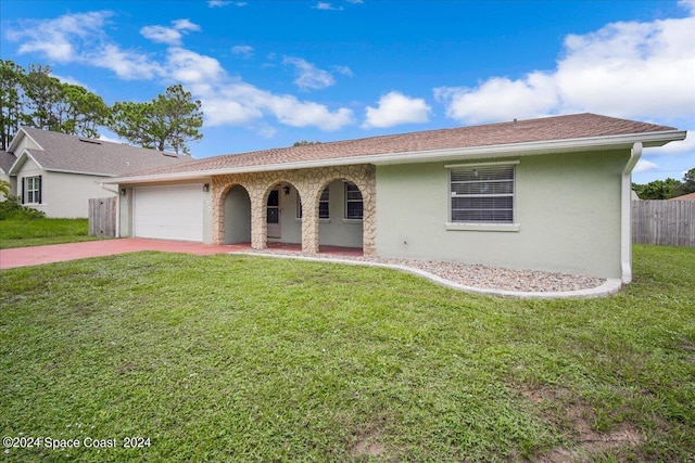 single story home featuring a front yard and a garage