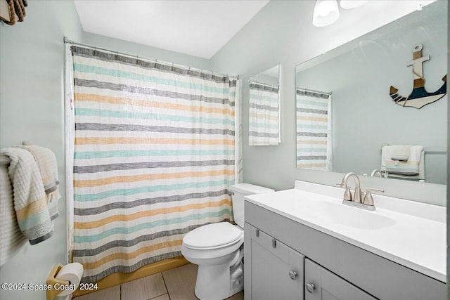 bathroom with vanity, toilet, curtained shower, and tile patterned floors