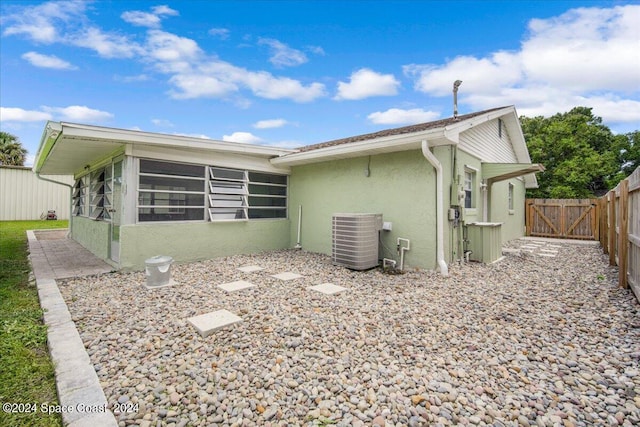 back of property featuring central air condition unit