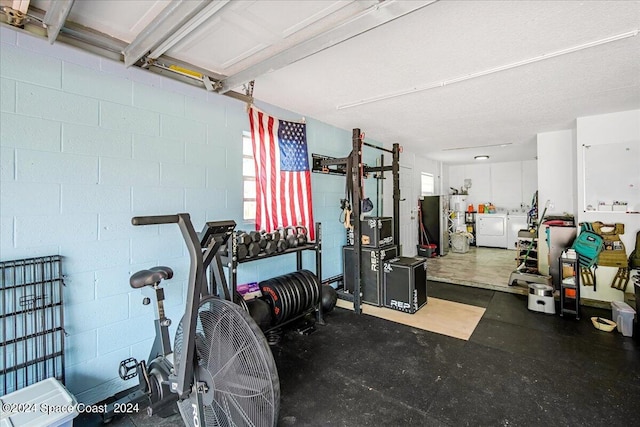 exercise room featuring washing machine and clothes dryer