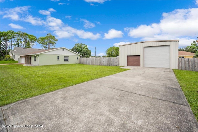 view of front of house with a garage and a front lawn