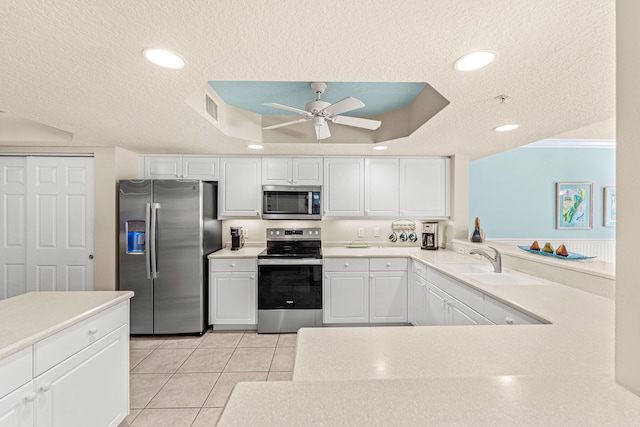 kitchen featuring a textured ceiling, appliances with stainless steel finishes, a sink, and visible vents