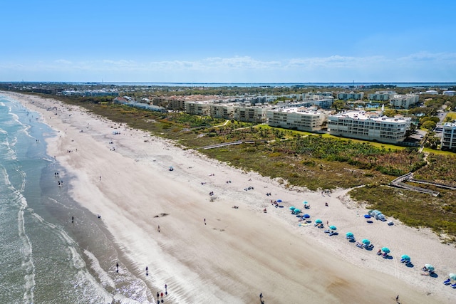 drone / aerial view with a city view, a water view, and a beach view