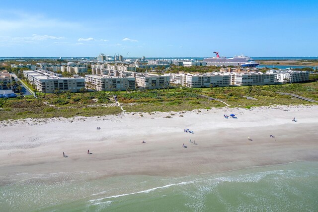 birds eye view of property featuring a view of city, a water view, and a view of the beach