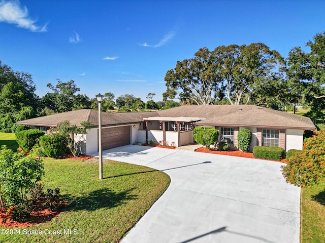 ranch-style home with a front yard and a garage