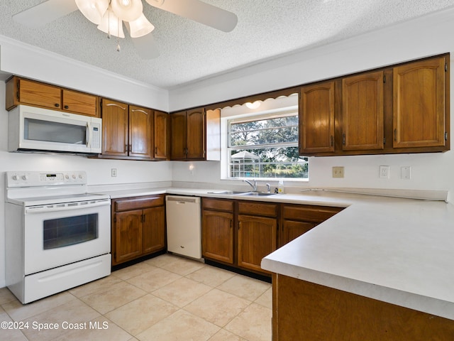 kitchen featuring a textured ceiling, white appliances, ceiling fan, sink, and light tile patterned flooring