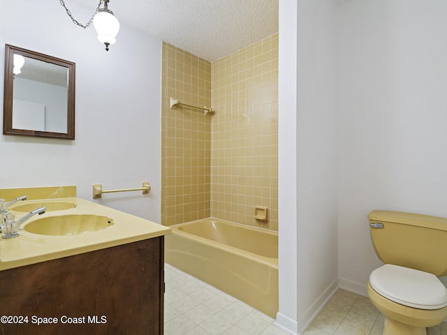 full bathroom with vanity, a textured ceiling, tile patterned flooring, toilet, and tiled shower / bath