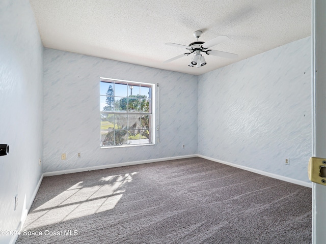 empty room with carpet flooring, a textured ceiling, and ceiling fan