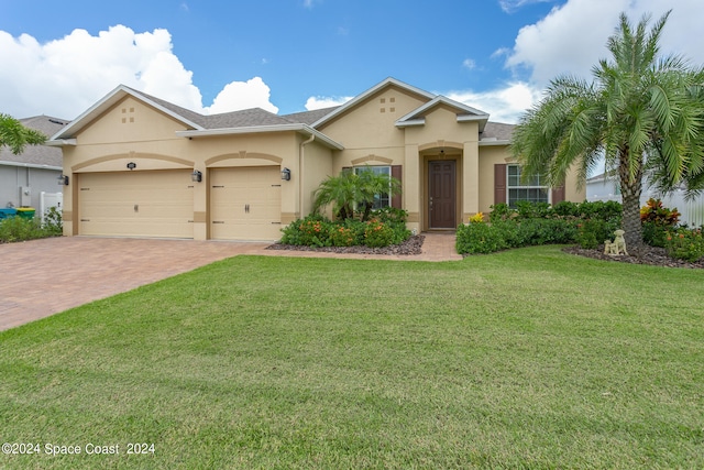 view of front of home featuring a garage and a front lawn