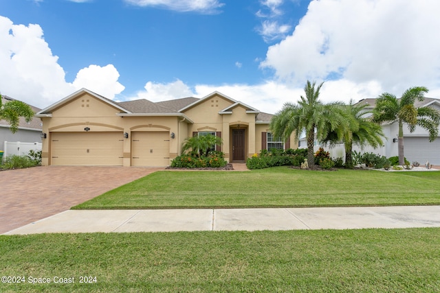 view of front of property featuring a garage and a front yard