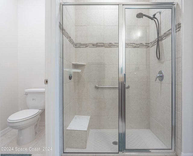 bathroom with walk in shower, tile patterned flooring, and toilet