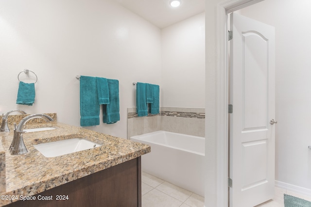 bathroom featuring vanity, tile patterned floors, and a bathing tub