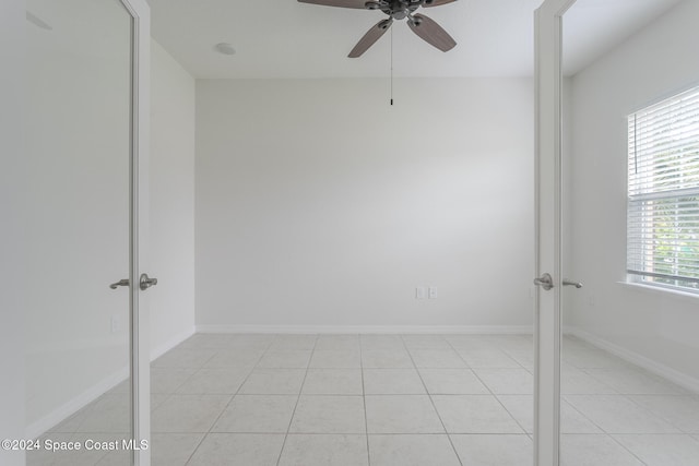 spare room with light tile patterned flooring and ceiling fan