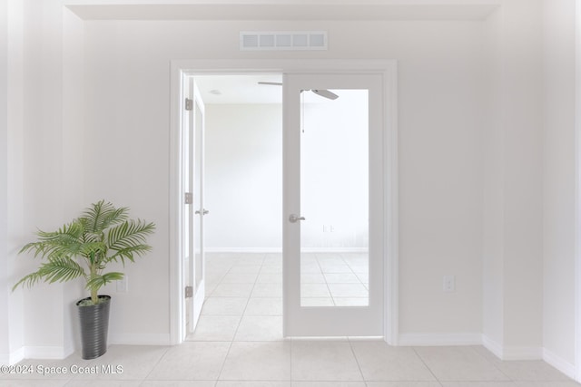 corridor featuring light tile patterned floors