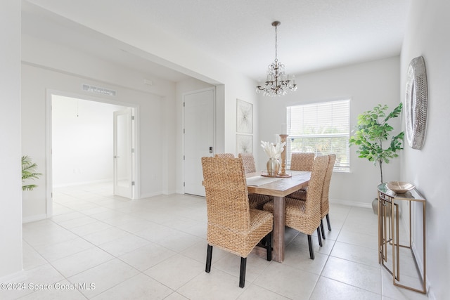 tiled dining space featuring an inviting chandelier