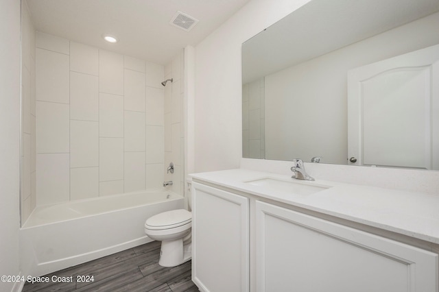 full bathroom with toilet, shower / bath combination, wood finished floors, vanity, and visible vents