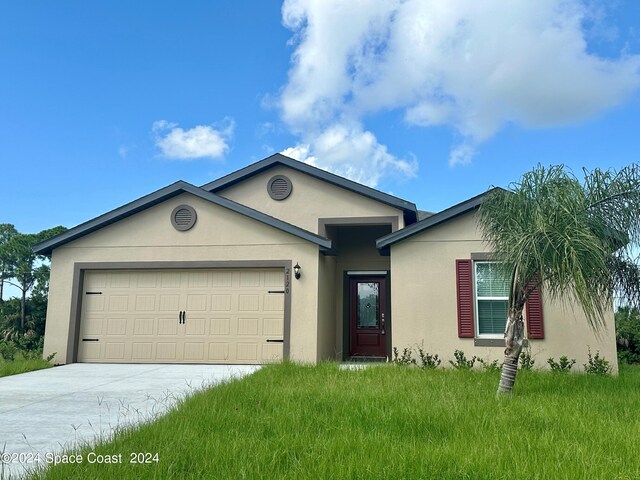 ranch-style home with an attached garage, driveway, and stucco siding