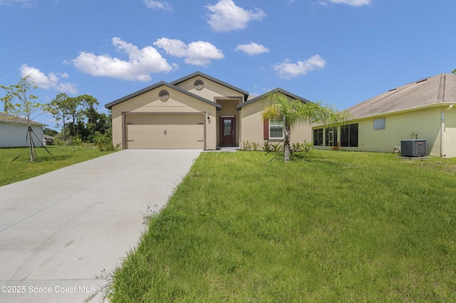 2120 Garbett Ave SW, Palm Bay, FL 32908 - ranch-style home with central AC, concrete driveway, an attached garage, and a front lawn