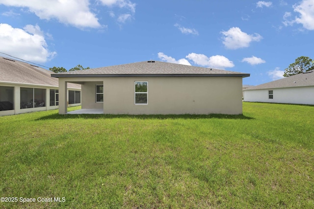 2120 Garbett Ave SW, Palm Bay, FL 32908 - rear view of house with stucco siding, a lawn, and a patio area