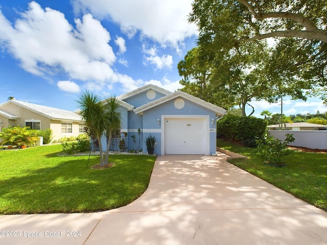 view of front of house with a front yard and a garage