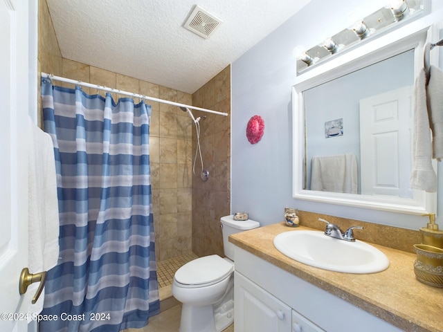 bathroom with a shower with curtain, vanity, toilet, and a textured ceiling