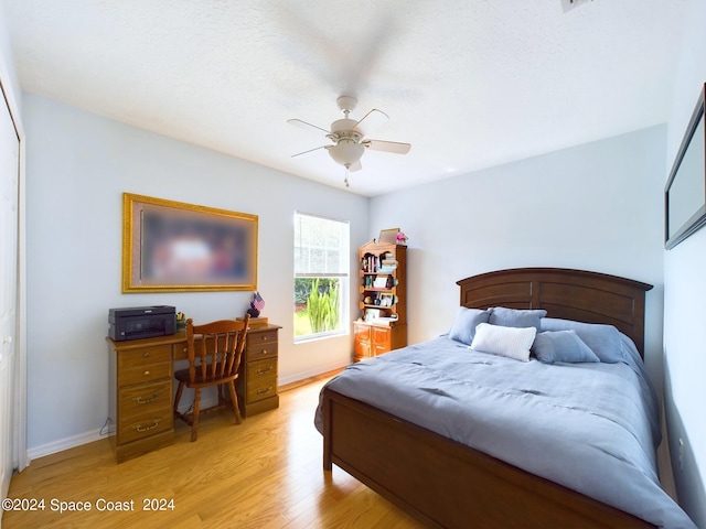 bedroom with ceiling fan and light hardwood / wood-style floors