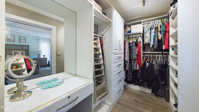 spacious closet with hardwood / wood-style flooring and ceiling fan