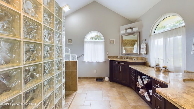 bathroom featuring tile patterned flooring, vanity, and high vaulted ceiling