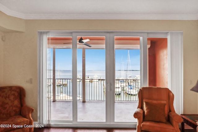 entryway with ornamental molding, french doors, a water view, and hardwood / wood-style floors