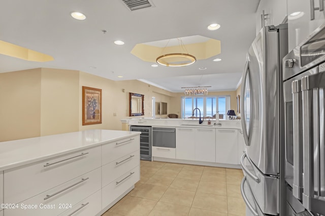 kitchen with stainless steel fridge, beverage cooler, sink, white cabinetry, and light tile patterned flooring