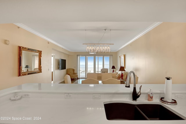 kitchen featuring french doors, crown molding, and sink