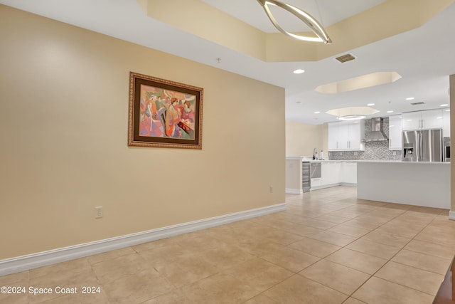 unfurnished living room with sink and light tile patterned floors