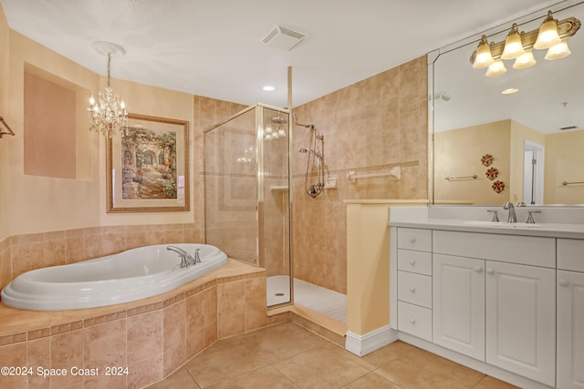 bathroom with tile patterned floors, independent shower and bath, and vanity