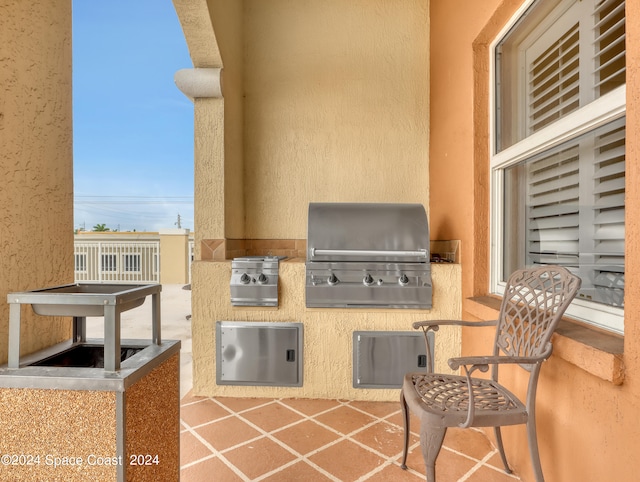 view of patio with an outdoor kitchen and a grill